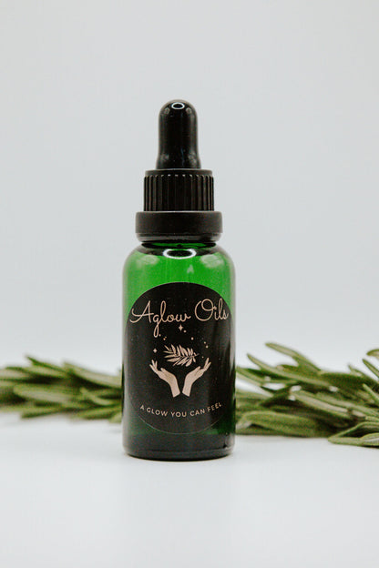 Green bottle with dropper and rosemary